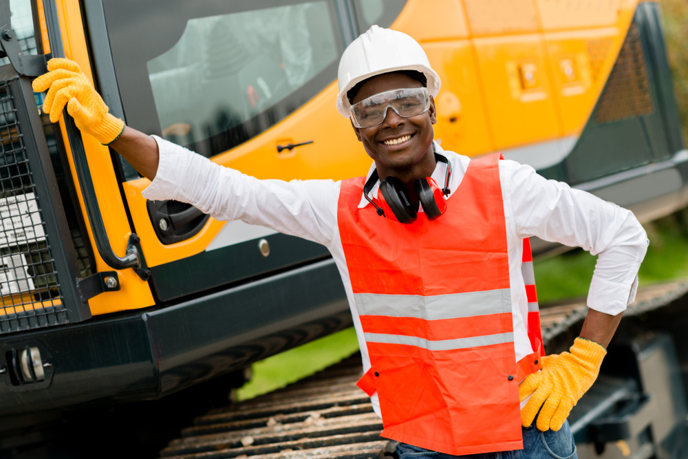 Construction worker with a crane at the background